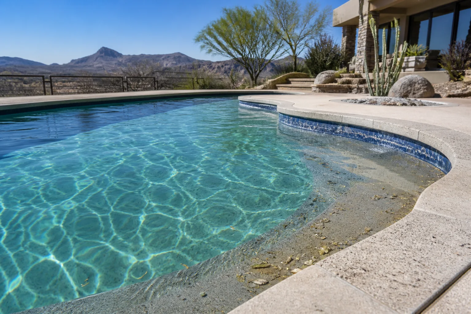 Fountain Hills pool showing windblown desert debris and mineral buildup at the waterline