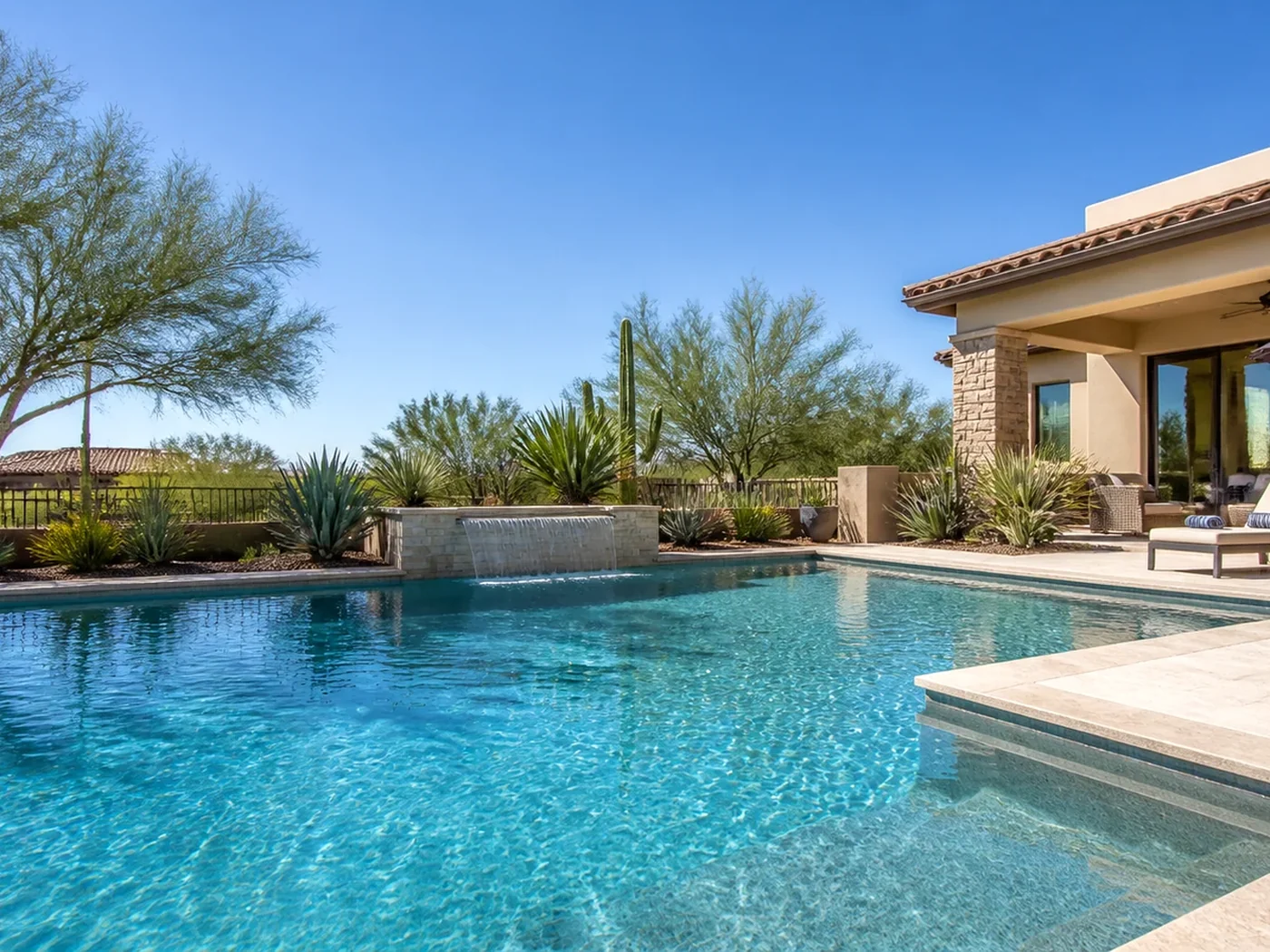 Clear Value Pools technician testing water beside a sun-exposed Arizona residential and commercial pool.